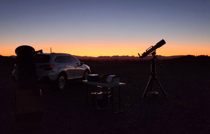 A picture containing outdoor, sky, telescope, tripod

Description automatically generated