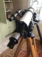 A telescope on a tripod

Description automatically generated